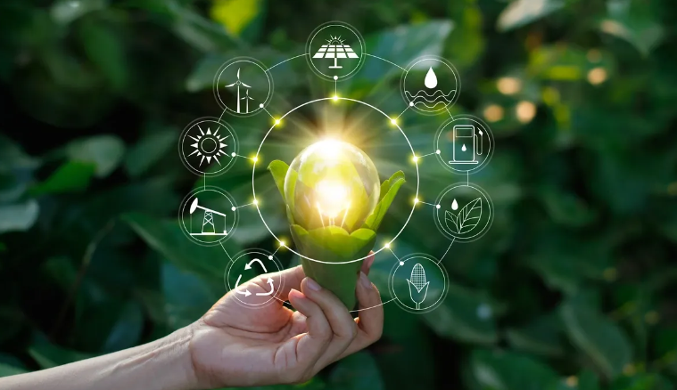Hand holding lightbulb with sustainability icons